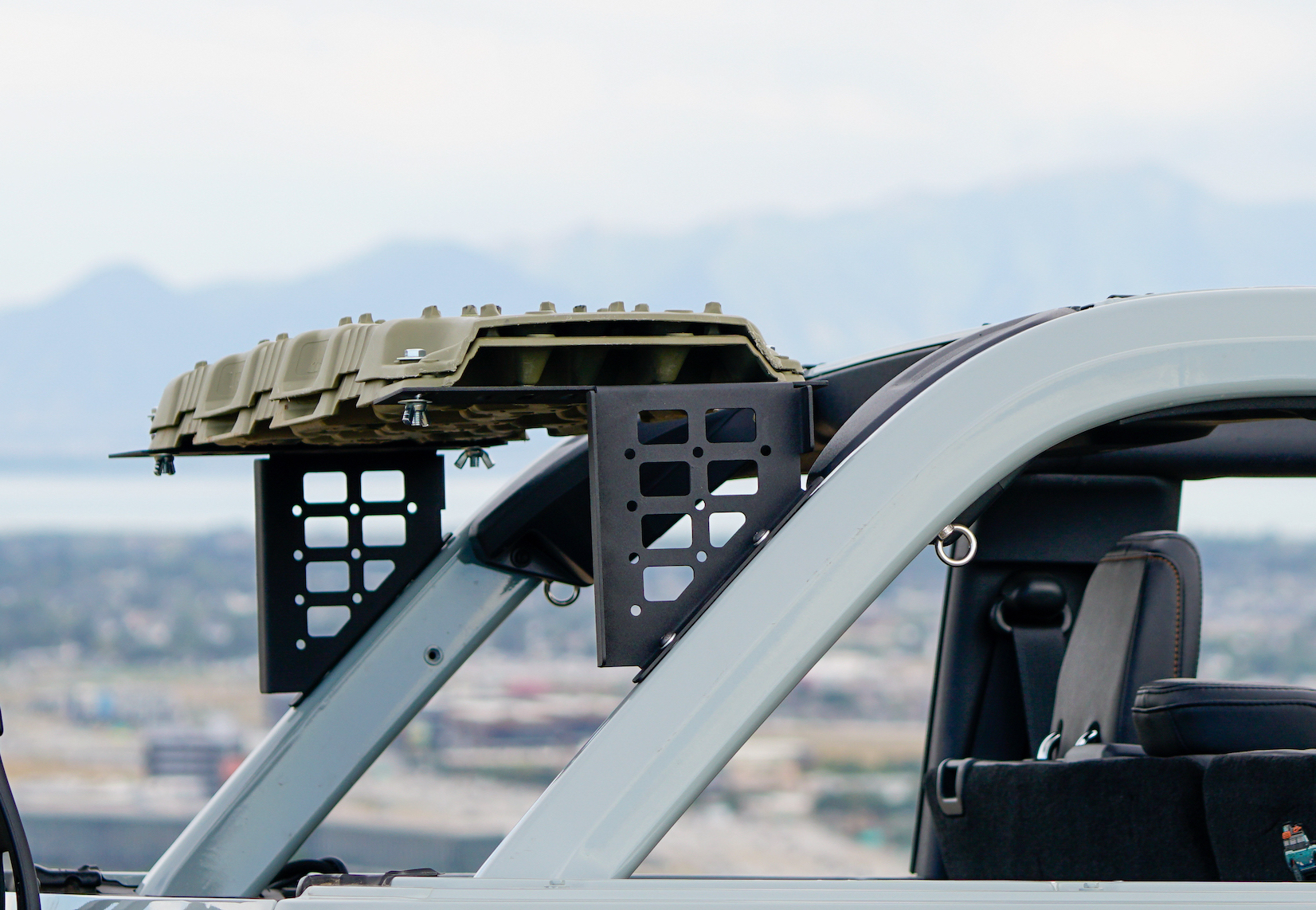 I designed and fabricated traction board mounts for Bronco roll bar